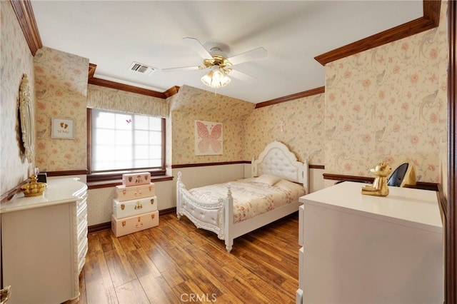 bedroom with hardwood / wood-style flooring, ceiling fan, and crown molding