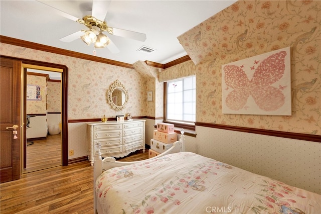 bedroom featuring crown molding, ceiling fan, and hardwood / wood-style flooring