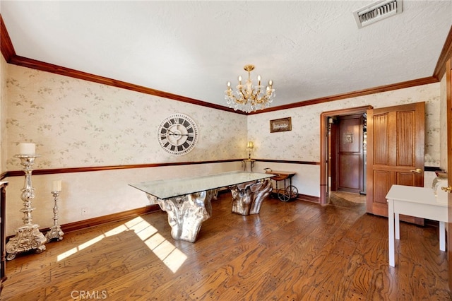 unfurnished dining area featuring a notable chandelier, dark wood-type flooring, and ornamental molding