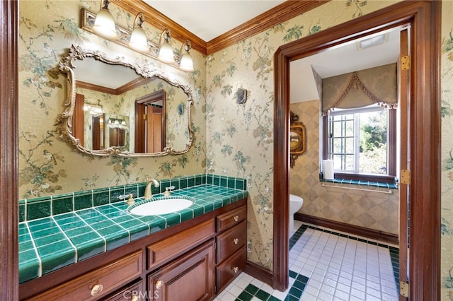 bathroom featuring crown molding, vanity, tile patterned floors, and toilet