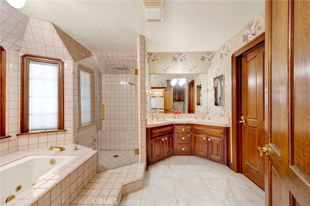 bathroom featuring vanity and independent shower and bath