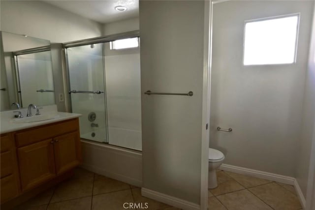 full bathroom with vanity, tile patterned floors, toilet, and combined bath / shower with glass door