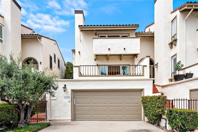 view of front of property featuring a garage and a balcony