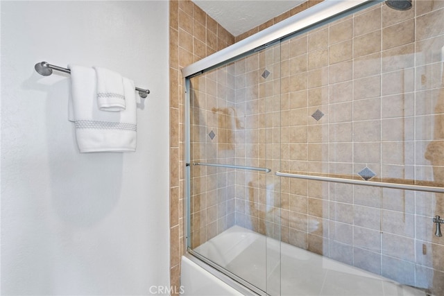 bathroom with shower / bath combination with glass door