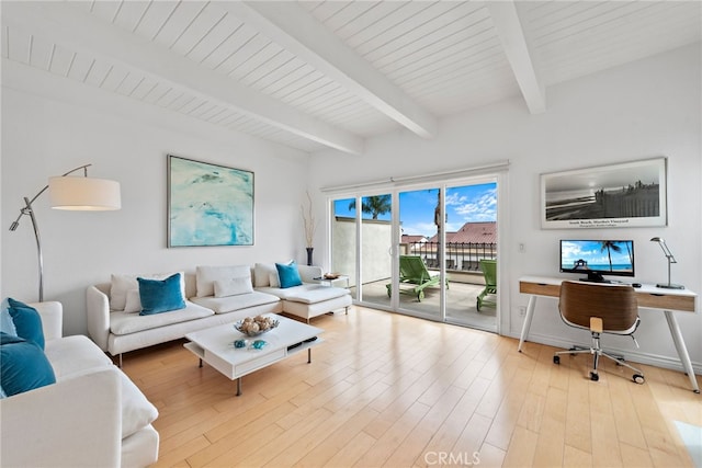 living room featuring beam ceiling and light hardwood / wood-style floors