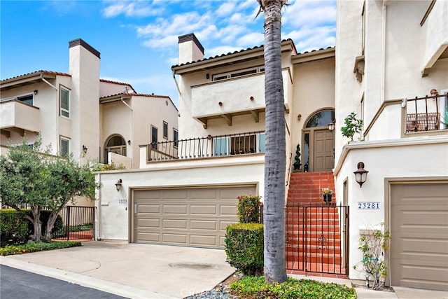 view of front of property with a balcony and a garage