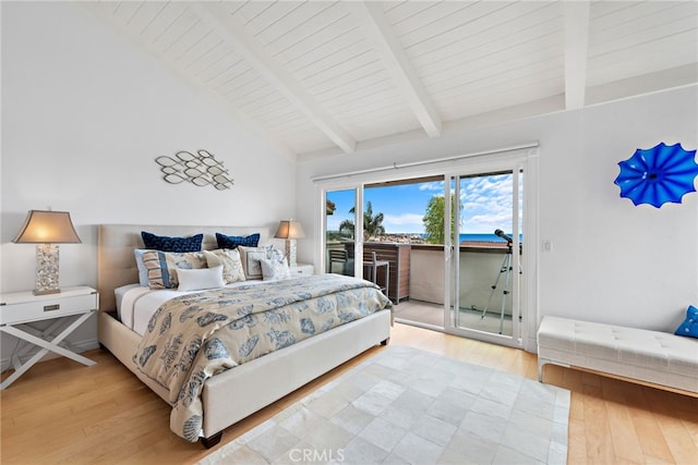 bedroom featuring light hardwood / wood-style flooring, vaulted ceiling with beams, and access to outside