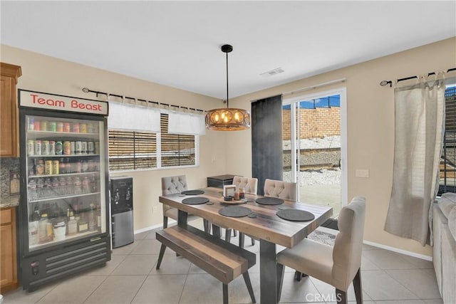 dining room featuring a notable chandelier and light tile patterned floors