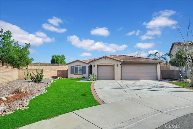 view of front of house featuring a garage and a front yard