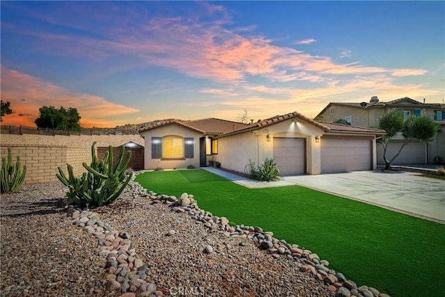 view of front of home featuring a yard and a garage