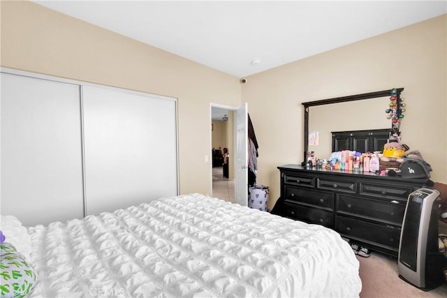 carpeted bedroom with a closet