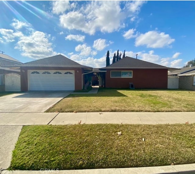 single story home featuring a garage and a front lawn