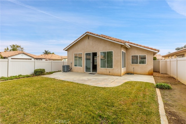 back of house with a yard, central AC unit, and a patio area