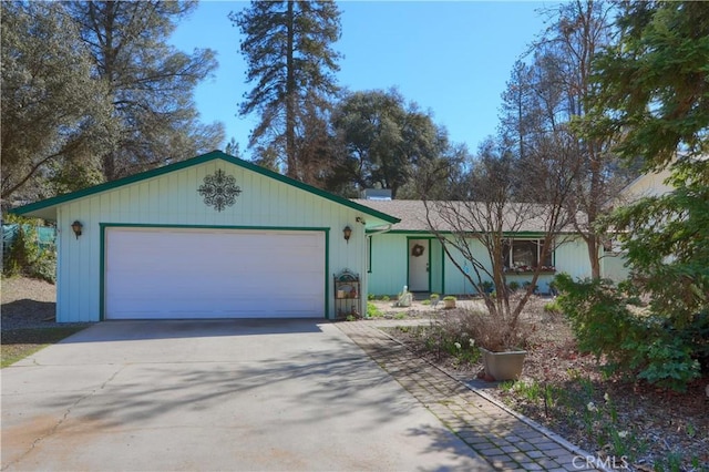 ranch-style house featuring an attached garage and concrete driveway