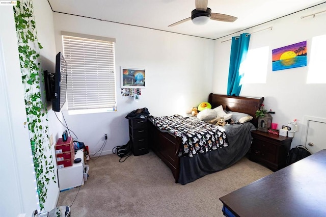 bedroom with light carpet and ceiling fan