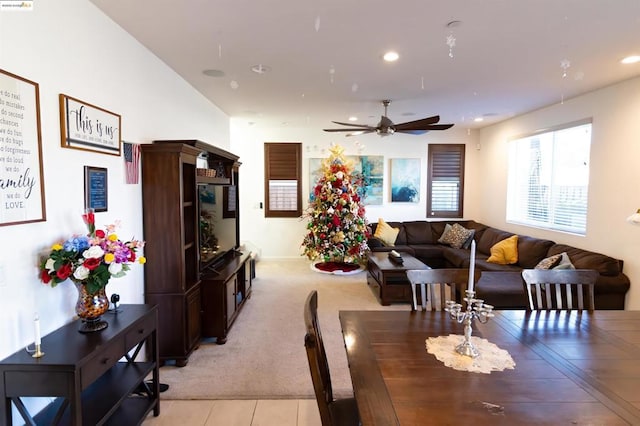 dining space with light colored carpet and ceiling fan