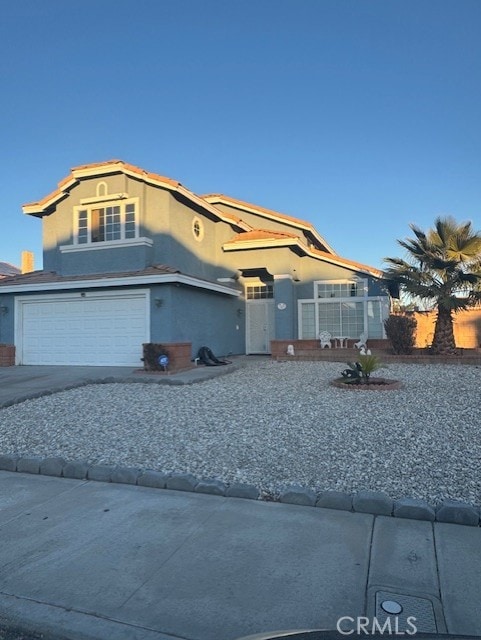 mediterranean / spanish house with stucco siding, driveway, and an attached garage