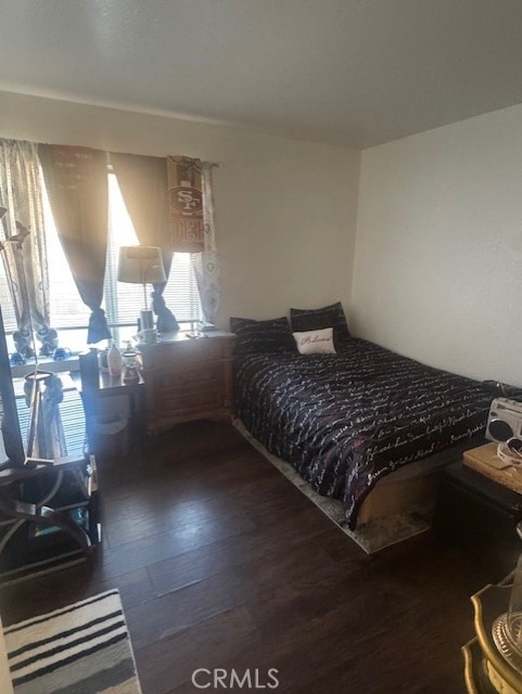 bedroom featuring dark wood-type flooring