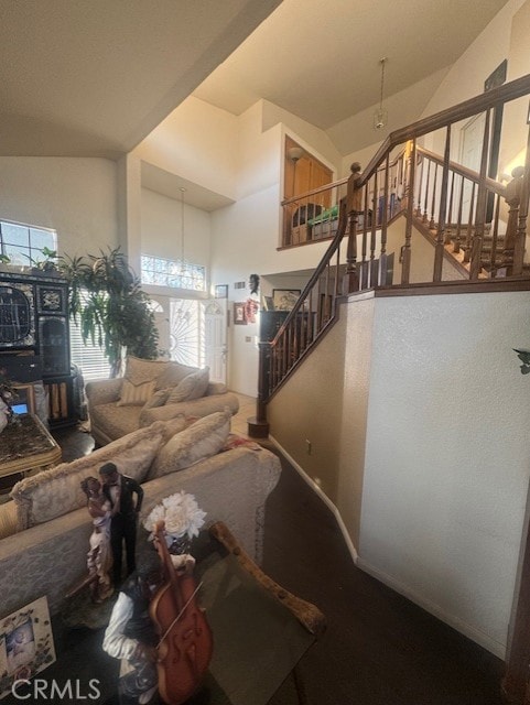 living room with a notable chandelier and high vaulted ceiling