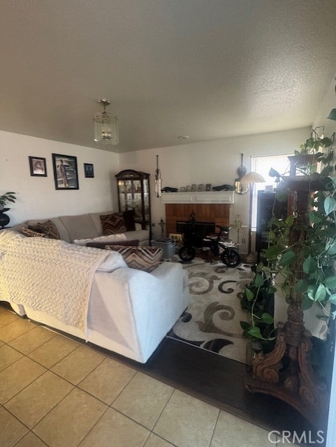 living room with tile patterned floors and a textured ceiling