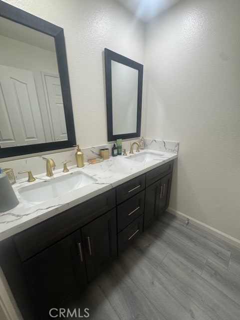 bathroom with vanity and wood-type flooring