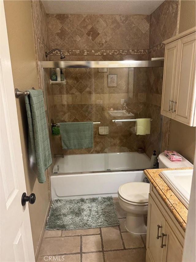 full bathroom featuring vanity, shower / bath combination with glass door, and toilet