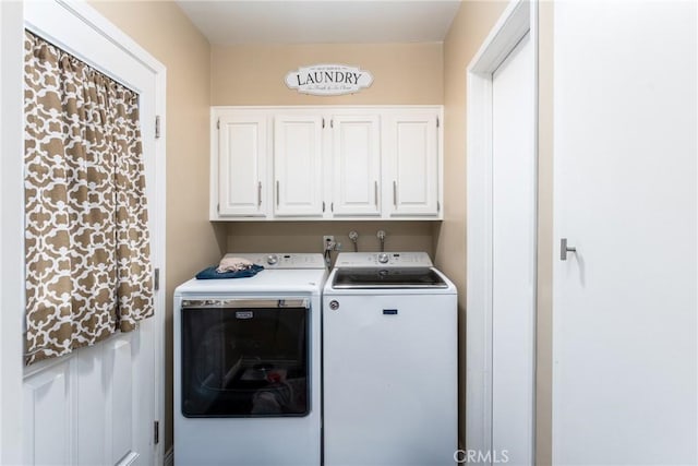 washroom with cabinets and independent washer and dryer