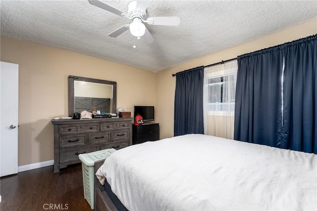 bedroom featuring a textured ceiling, dark hardwood / wood-style floors, and ceiling fan