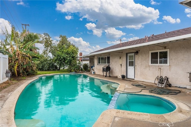 view of swimming pool with a grill and a patio area