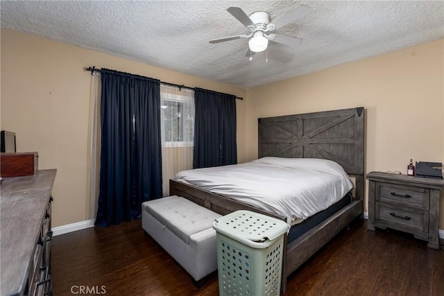 bedroom featuring a textured ceiling, dark wood-type flooring, and ceiling fan