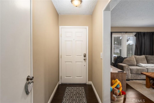 doorway featuring a textured ceiling and dark hardwood / wood-style flooring