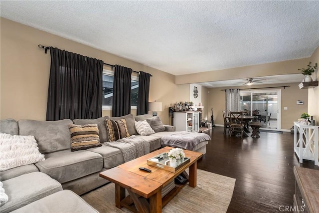 living room featuring bar area, a textured ceiling, and dark hardwood / wood-style flooring