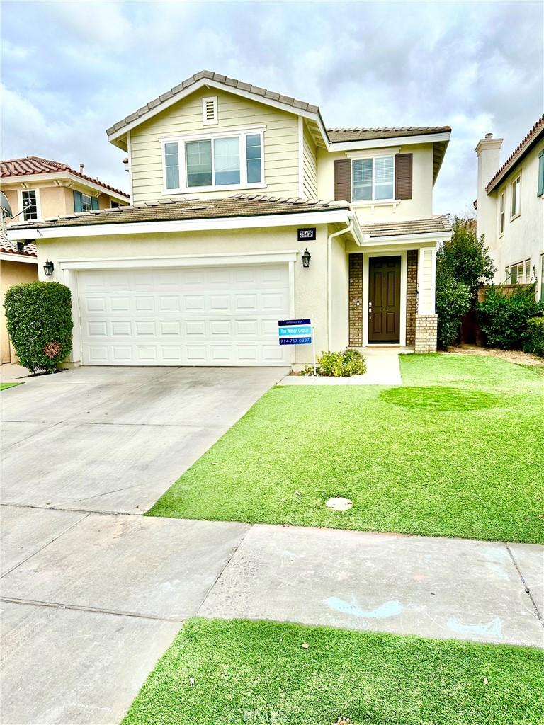 view of front of property with a garage and a front yard