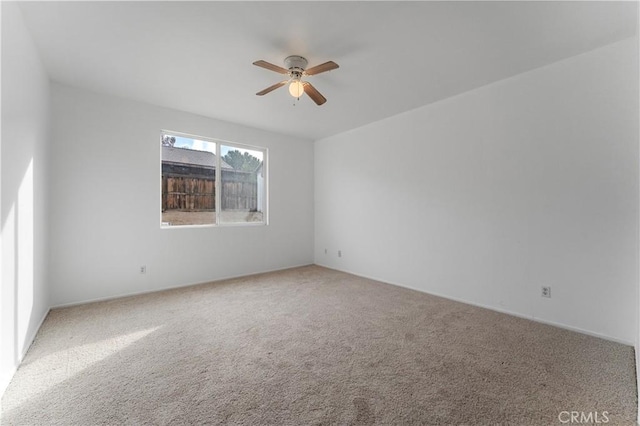 empty room featuring carpet floors and ceiling fan