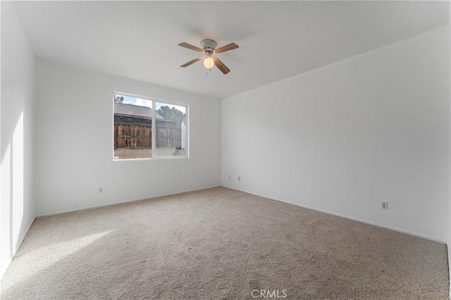 unfurnished room featuring a ceiling fan and carpet flooring