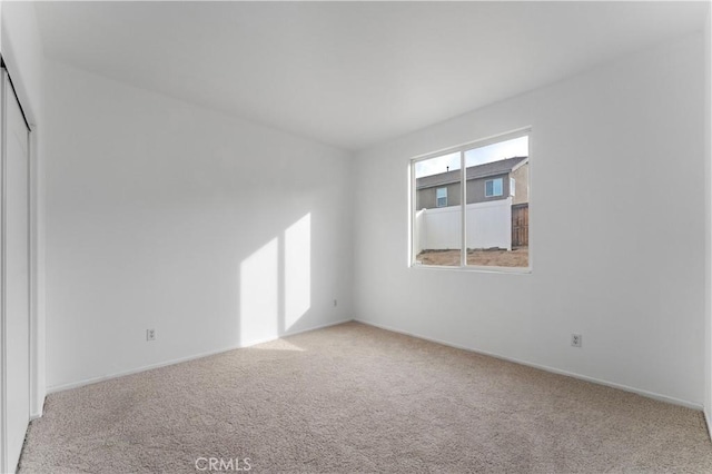 empty room featuring light colored carpet