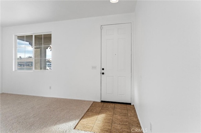 view of carpeted foyer entrance