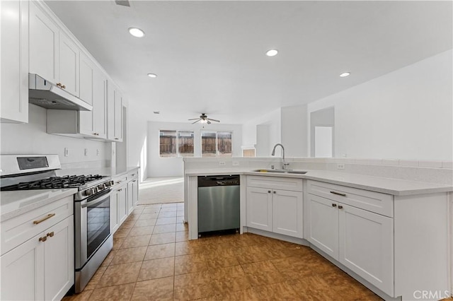 kitchen with white cabinetry, appliances with stainless steel finishes, kitchen peninsula, and sink