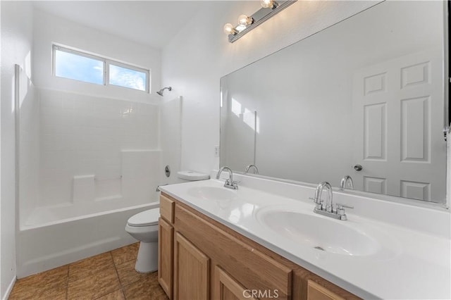 bathroom featuring double vanity, bathtub / shower combination, a sink, and toilet