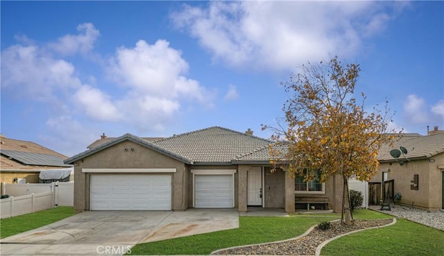 view of front of property featuring a garage and a front yard