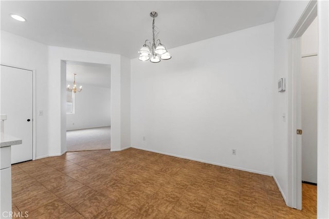 empty room featuring a notable chandelier