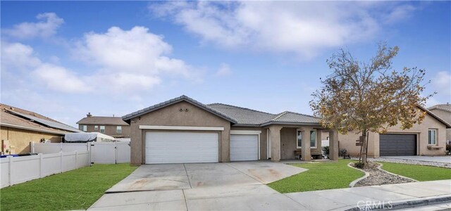 ranch-style house with a garage and a front lawn