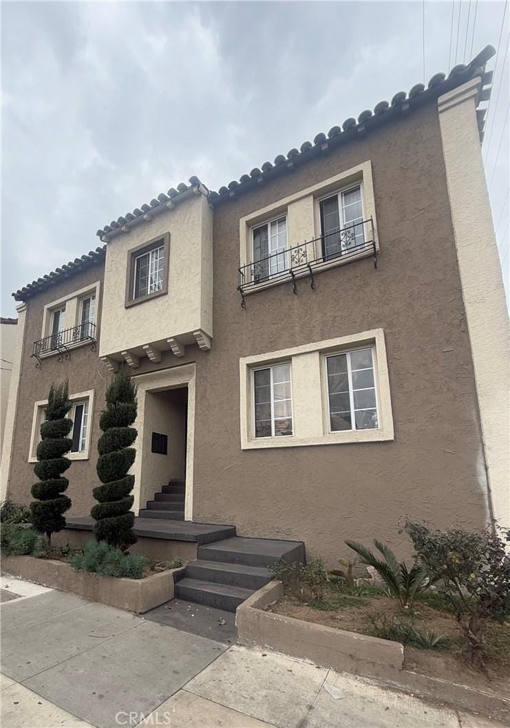 mediterranean / spanish home featuring a patio and a balcony