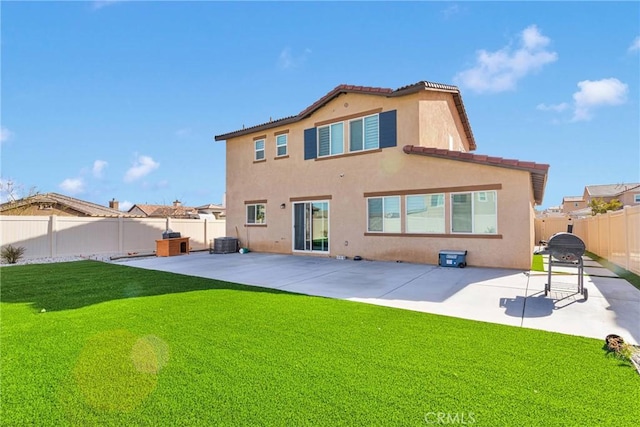 rear view of property with a patio, cooling unit, and a lawn