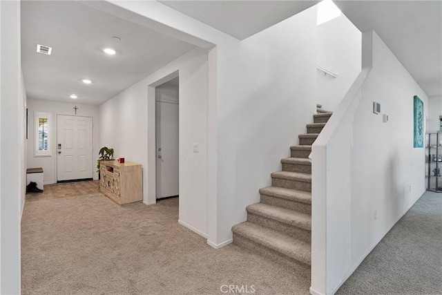 entrance foyer featuring light carpet