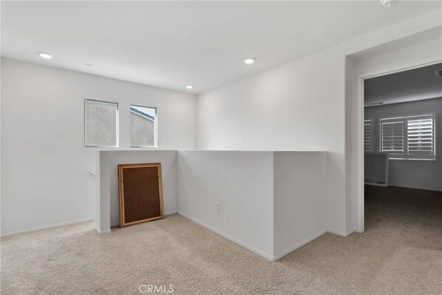 spare room featuring light colored carpet