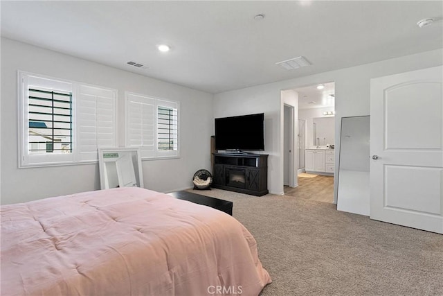 carpeted bedroom with connected bathroom