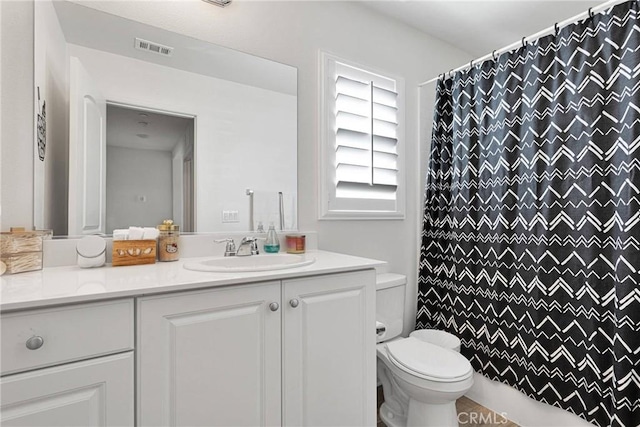 bathroom featuring vanity, toilet, and a shower with shower curtain