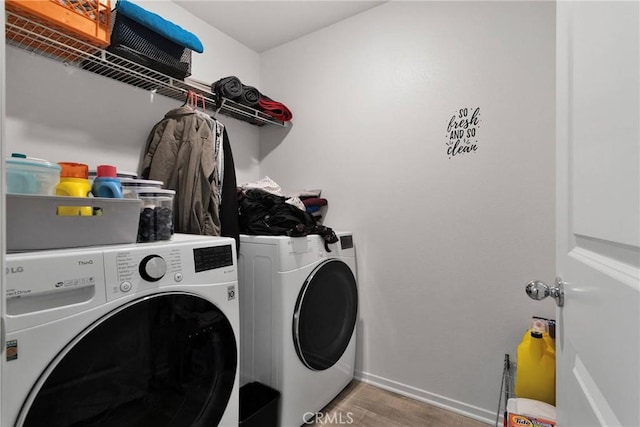 clothes washing area featuring washer and dryer