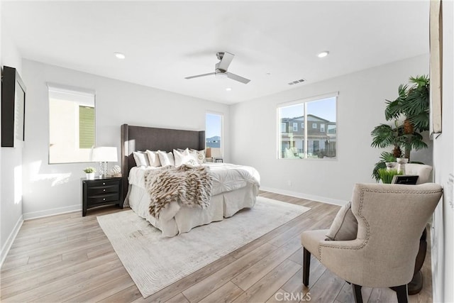 bedroom with ceiling fan and light wood-type flooring